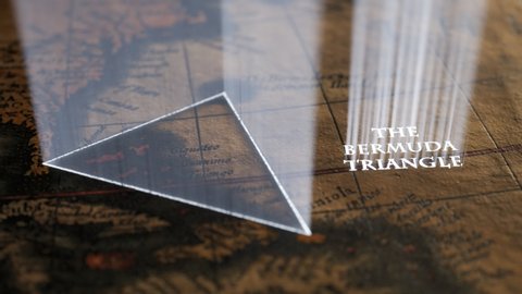 Famous Bermuda triangle marked with light shafts on an old, vintage map. A magical sign slowly appears hinting the approximate spot of mysterious disappearing and ship disasters over the years.
