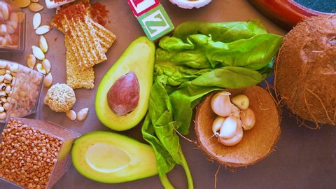 Foods High in Zinc as avocado, spinach, garlic, seeds, nuts, sea food, dairy food, Healthy diet concept. Top view 4K