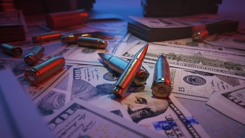 Shiny, brand new ammo bullets in the middle of mafia table. A lot of dollar bills stacked on top of it  Gangster crime wealth and deadly force. Neon red and blue lights illuminating the cash.. 4KHD
