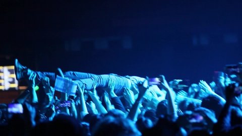MOSCOW-7 DECEMBER,2014:Matisyahu surfing through the crowd after stage diving on concert in night club