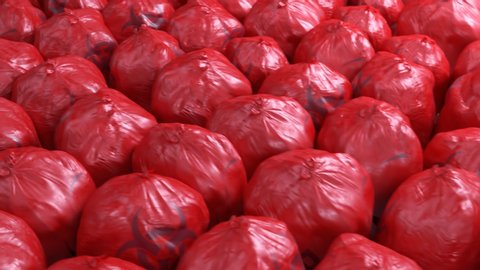 Seamless looping shot with countless red biohazard trash bags full of dangerous waste. Medical, biomedical of infectious solid or non-sharp waste disposal. Waste storage in bright red bin plastic bags