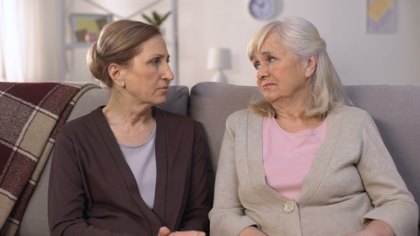 Mature friends supporting and comforting each other sitting on sofa pain of loss | Shutterstock HD Video #1033798544