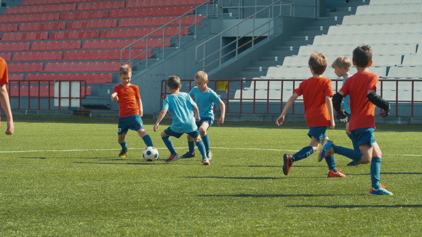 Kids playing soccer on big stadium, dribbling and attacking goal post Royalty-Free Stock Footage #1033798799