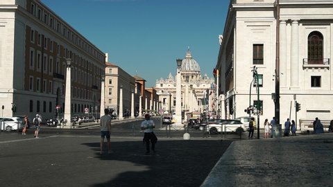 Rome, JULY 03, 2019: Tourists walk along the Via della Conciliazione, with San Pietro in the background. time lapse effect