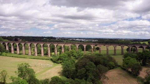 Harrogate, United Kingdom (UK) - 07 06 2019: Backwards Dolly Shot of Crimple Valley Viaduct in North Yorkshire on a Sunny Summer’s Day with a Train Entering Frame