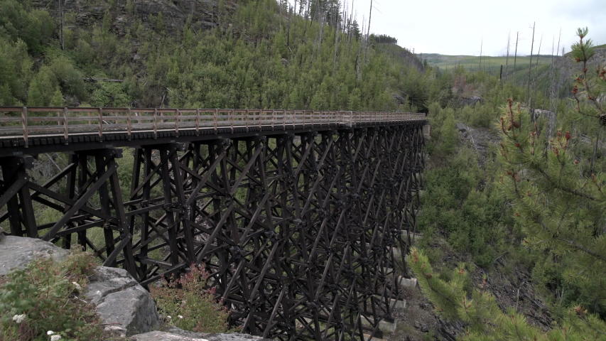 Myra Canyon Trestles National Heritage Site 4K UHD. Cyclists cross one of the trestles in Myra-Bellevue Provincial Park in Kelowna. 4K UHD.
