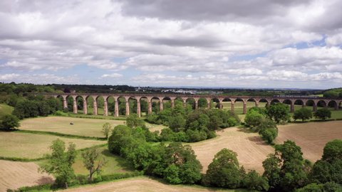 Harrogate, United Kingdom (UK) - 07 06 2019: Forwards Dolly Shot of Crimple Valley Viaduct in North Yorkshire with a Northern Train Crossing