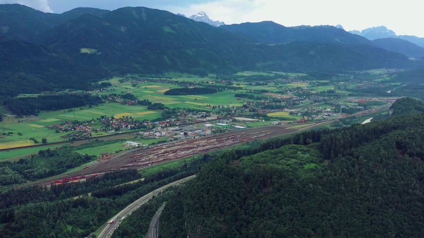 VILLACH, AUSTRIA - JUNE, 2019: Aerial drone view of Villach suburb with beautifil nature. Roads and railroads from above.