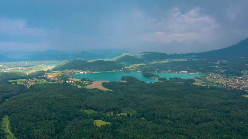 VILLACH, AUSTRIA - JUNE, 2019: Aerial drone view of Villach suburb with beautifil nature. Roads and railroads from above.