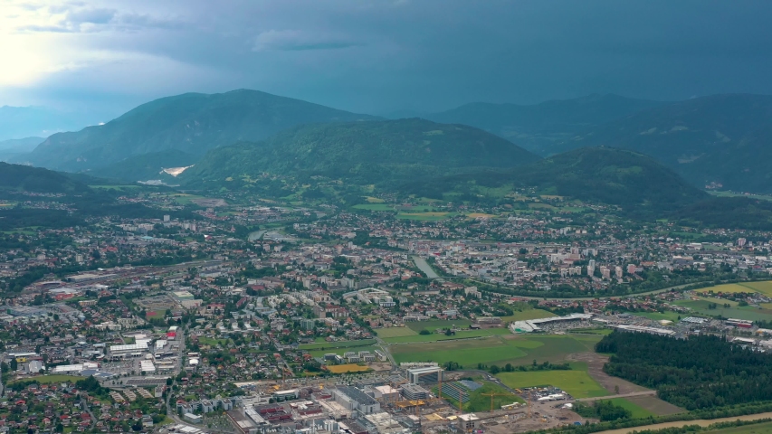 VILLACH, AUSTRIA - JUNE, 2019: Aerial drone view of Villach suburb with beautifil nature. Roads and railroads from above.