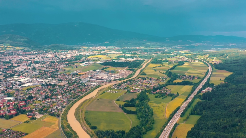 VILLACH, AUSTRIA - JUNE, 2019: Aerial drone view of Villach suburb with beautifil nature. Roads and railroads from above.
