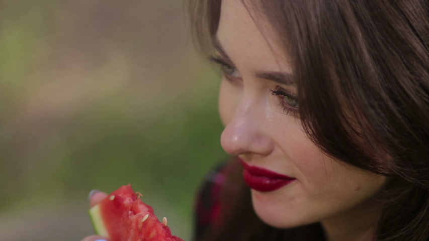 Pretty woman seductively eating watermelon