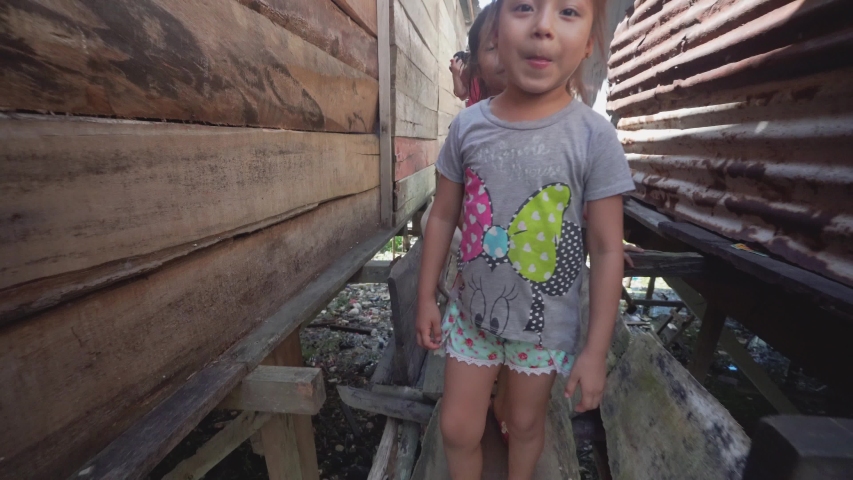Iquitos, Peru. Circa 2019. Pueblo in coast amazon river people lives wood houses floating. Childrens playing in the water