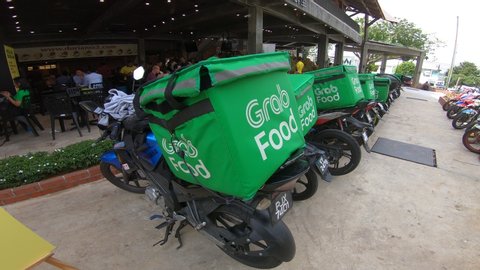 Kuala Lumpur, Malaysia - July 18, 2019 : Grab Food Motorbike at the street. Food delivery service through its app.