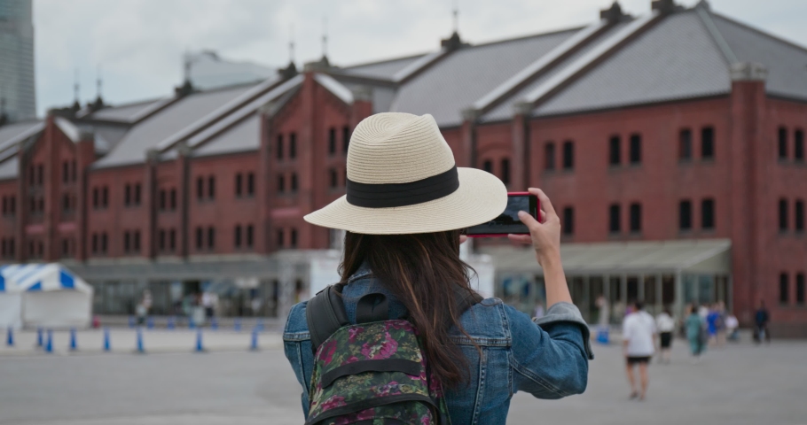 Woman take photo with cellphone in Yokohama red warehouse