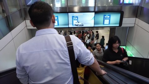 Bangkok, Thailand - April 29, 2019: People taking the MRT train in Bangkok. Everyday Bangkokian and tourist takes the MRT and BTS train to work and travel. People rush to get into train at rush hour.