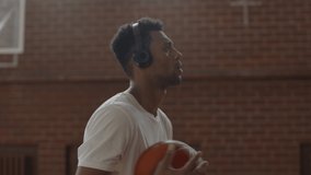 CU Young confident African American black college basketball player in listening to music during training. Shot on ARRI Alexa Mini, 4K RAW graded footage