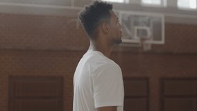 CU Young confident African American black college basketball player practicing shots in indoor arena. Shot on ARRI Alexa Mini, 4K RAW graded footage