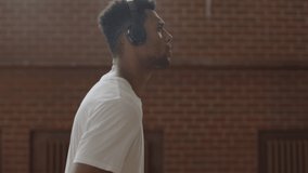 CU Young confident African American black college basketball player in listening to music during training. Shot on ARRI Alexa Mini, 4K RAW graded footage