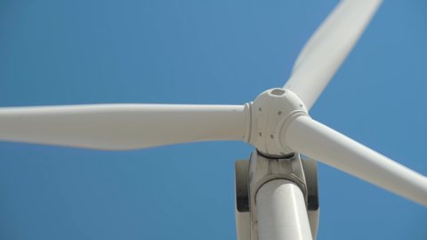 Wind generator on bright cloudy sky background