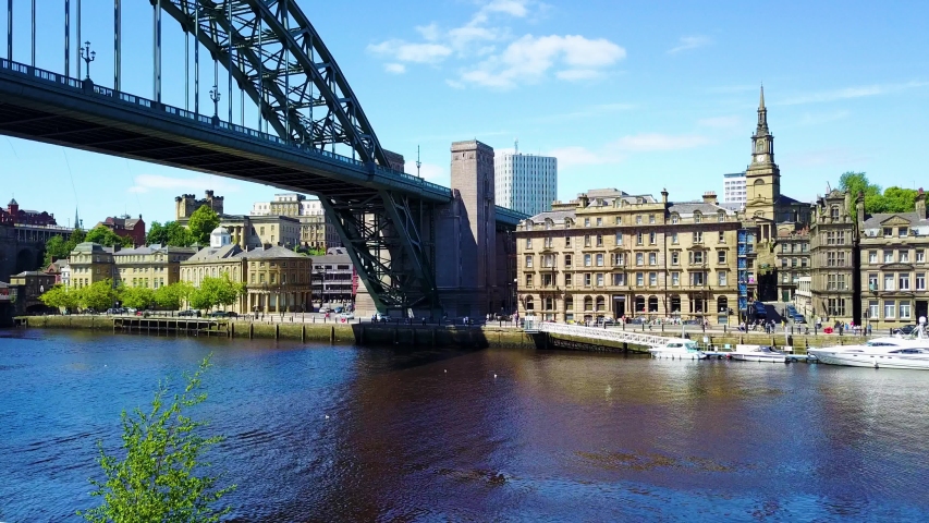 Arial footage of the Tyne bridge and Newcastle skyline in Newcastle Upon Tyne on a sunny day Royalty-Free Stock Footage #1033848068