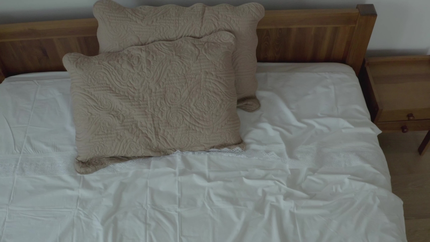 Tidy clean bedroom in a minimalistic style. Shot with drone.