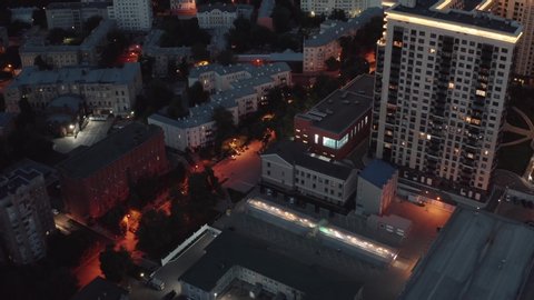 Flight above Night City buildings on drone, aerial view 4K