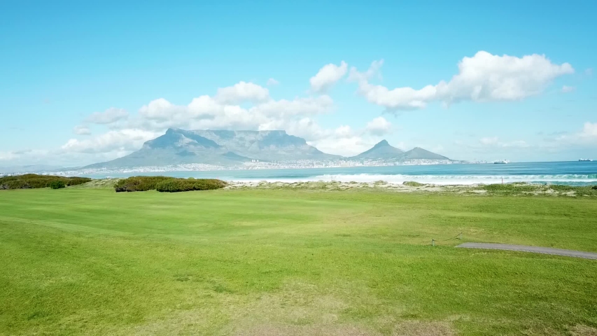 Aerial Shot of ocean waves and Table Mountain in Cape Town, South Africa