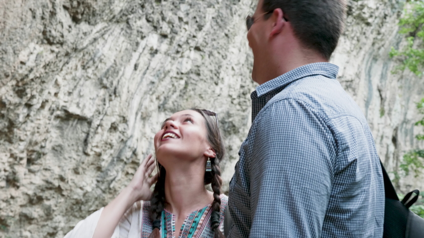 Young couple looking up at the mountain. Close up shot
