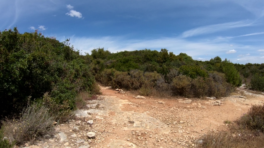 Walking along a trail in the Algarve Coast, near Praia da Marinha beach - Algarve, south of Portugal