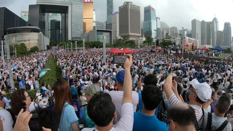 HONG KONG – 30 JUNE 2019: Wide angle view of people participating in pro police demonstration, showing support for police amidst turbulent anti extradition law protests in Hong Kong