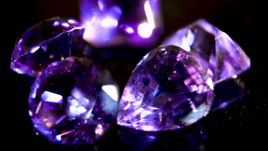 Close-up. Purple amethyst. The brilliance of the facets of a semi-precious purple crystal. Semiprecious stone. Precious stone