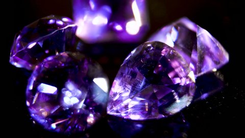 Close-up. Purple amethyst. The brilliance of the facets of a semi-precious purple crystal. Semiprecious stone. Precious stone