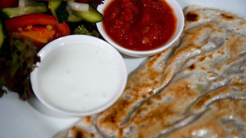 Exotic cuisine. Traditional cuisine of the Crimean Tatars. Pie of thin unleavened dough with filling and spicy seasonings