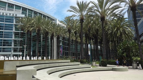 Anaheim, CA / USA - July 22, 2019: Pan and tilt from conference attendees walking by up to the Anaheim Convention Center