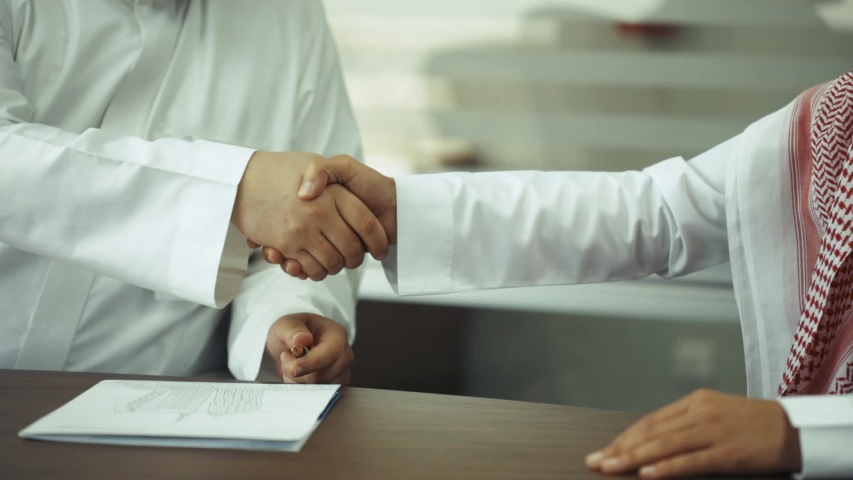 Two Saudi business men shaking hands | Shutterstock HD Video #1033875095