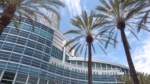 Anaheim, CA / USA - July 22, 2019: Smooth pan from exotic palms to the Anaheim Convention Center 