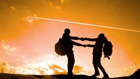 happy family dad with daughter teamwork tourists silhouette concept. slow motion video. dad and daughter with backpacks spinning holding hands. man and young happiness lifestyle girl a walking hiking