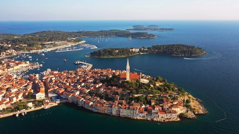 4K. Flight over beautiful Rovinj at sunset. Evening aerial panoramic view of the old town of Rovinj and islands, Istria, Croatia.