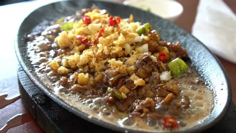hot and spicy sizzling pork sisig, famous snack or appetizer among local Filipinos