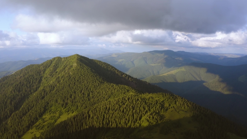 The flight above the mountain with a green forest. hyperlapse