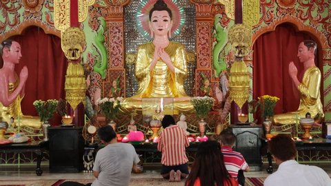 Penang / Malaysia - July 25th 2019: Visitors are offering their prayers in a Buddhist temple located in the city.