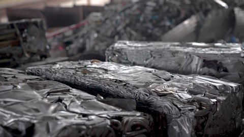Recycling scrap metal. In the frame briquettes pressed from aluminum waste.