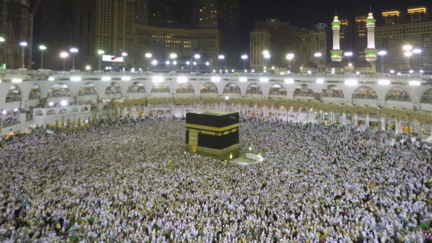 Time lapse video of Muslim pilgrims circling around the holy Kaaba at night during Hajj inside al Masjid al Haram in Mecca, Saudi Arabia. Camera zooms out from the Kaaba. | Shutterstock HD Video #1033912142