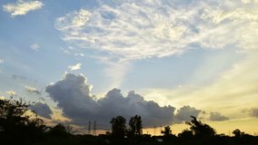 Beautiful blue sky with lots of clouds timelapse. Cloudy sky at sunset. Beautiful nature and puffy cloudscape. Blue sky turning dark in evening. Light rays shining through the clouds.
