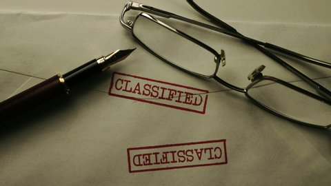 Close up of classified documents and glasses