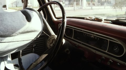 Man Driving an Old Vintage Pickup Truck. Dashboard Close-Up. Zoom In.