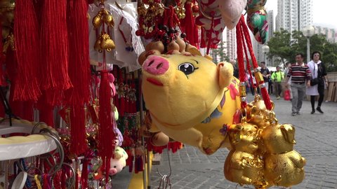 HONG KONG – FEBRUARY 2019: Chinese New Year decoration (for year of the Pig) for sale at a street vendor shop outside Wong Tai Sin temple in Hong Kong
