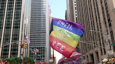 New York City, NY / USA - June 30th 2019: People marching and waving flags on the Queer Liberation March during World Pride in NYC.  Gay pride parade.