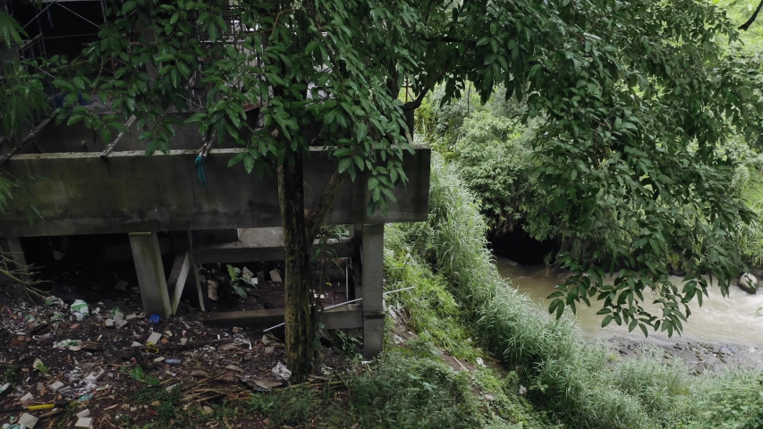 Aerial: illegal construction of hotels amongst a tropical rainforest. Ubud, Bali, Indonesia.
